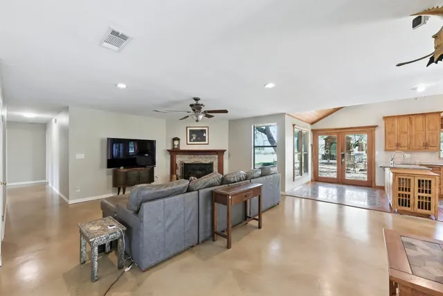 a living room with furniture a fireplace and a flat screen tv