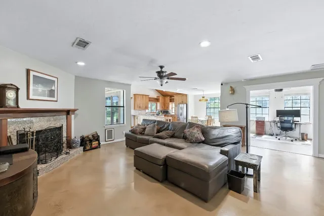 a living room with fireplace furniture and a fireplace