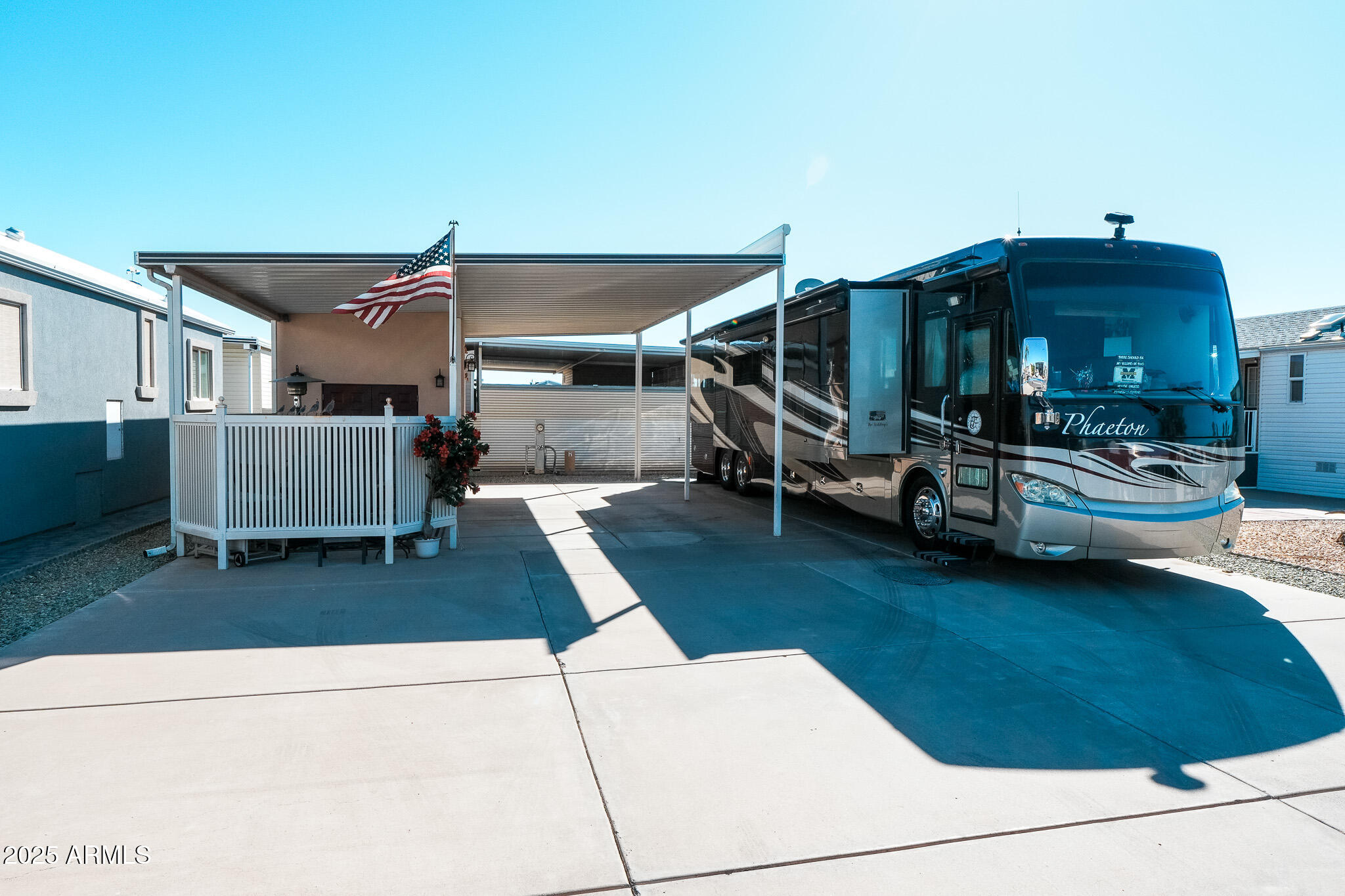 17200 West Bell Road, Unit 1242 Surprise, AZ 85374 - Photo 2 of 12 a view of a patio with table and chairs with wooden floor and fence