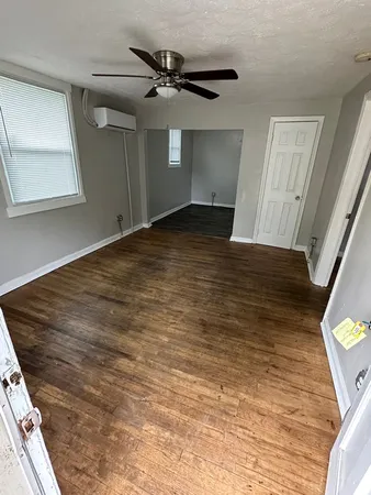 a view of a room with wooden floor and staircase