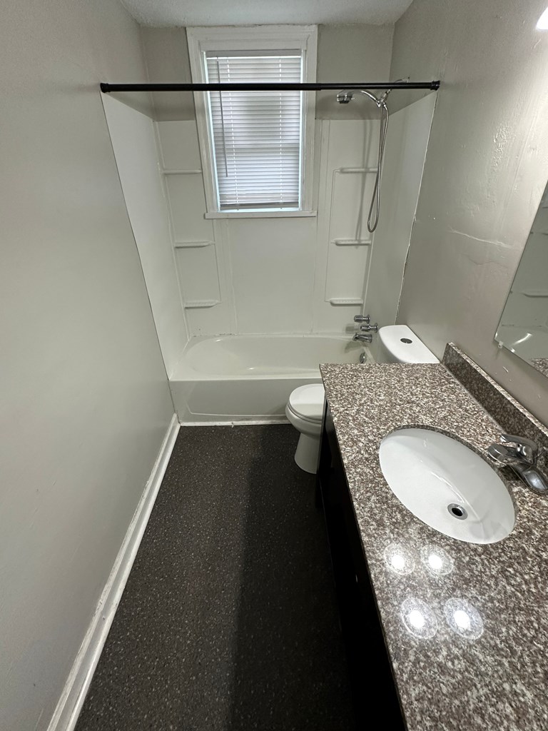 475 Mellon Street Columbus, GA 31903 - Photo 6 of 7 a bathroom with a granite countertop sink toilet and shower