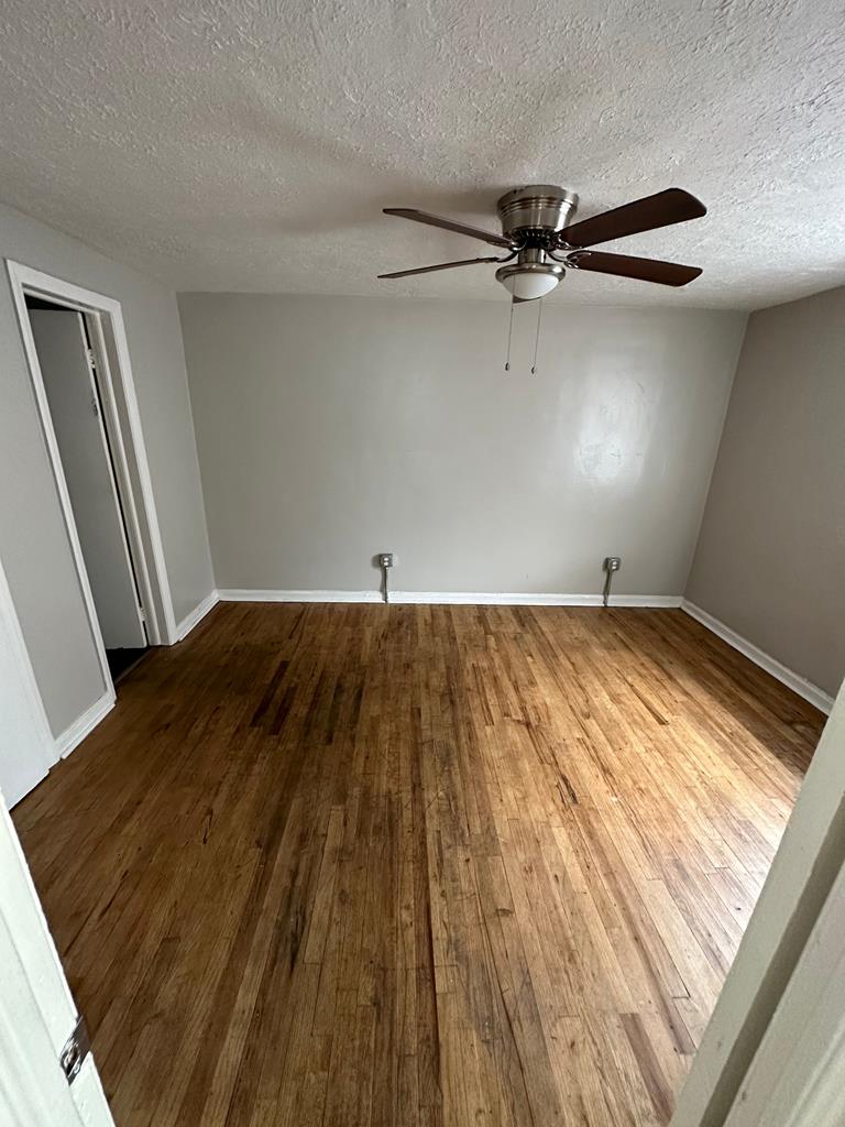 475 Mellon Street Columbus, GA 31903 - Photo 7 of 7 wooden floor in a hall with an empty room