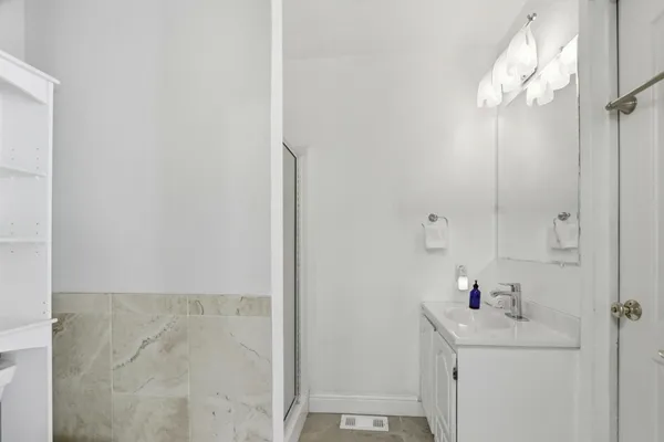 a bathroom with a sink a mirror and shower