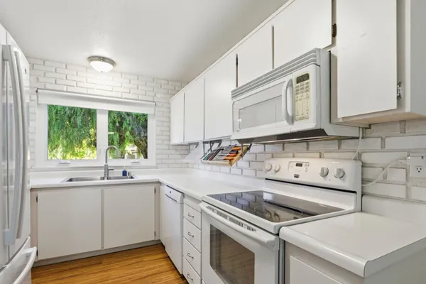 a kitchen with a sink stove and cabinets