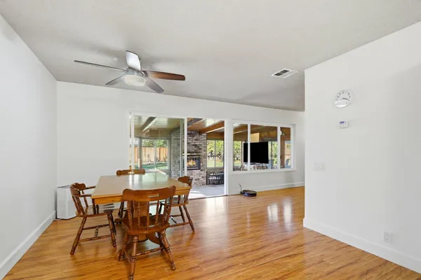 a view of a dining room with furniture window and wooden floor