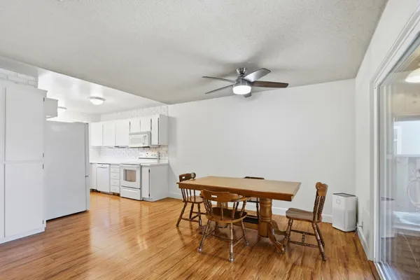 a view of a dining room with furniture and wooden floor