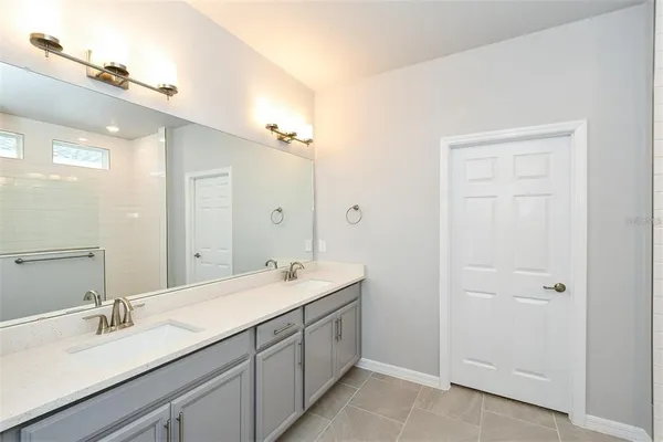 a spacious bathroom with a double vanity sink mirror and