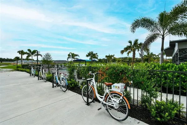 a view of a bike garage with cars parked