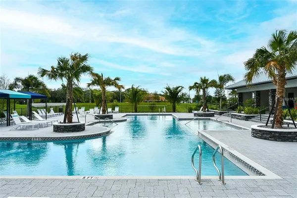 a view of a swimming pool with lounge chairs