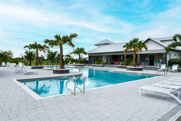 a view of a patio with swimming pool table and chairs