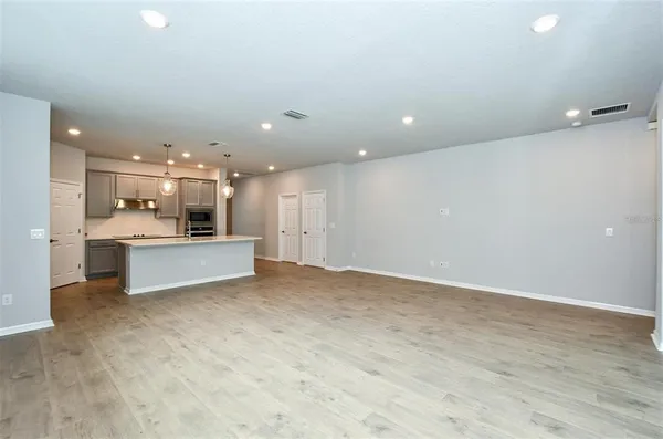 a view of kitchen with kitchen island and stainless steel appliances with cabinets