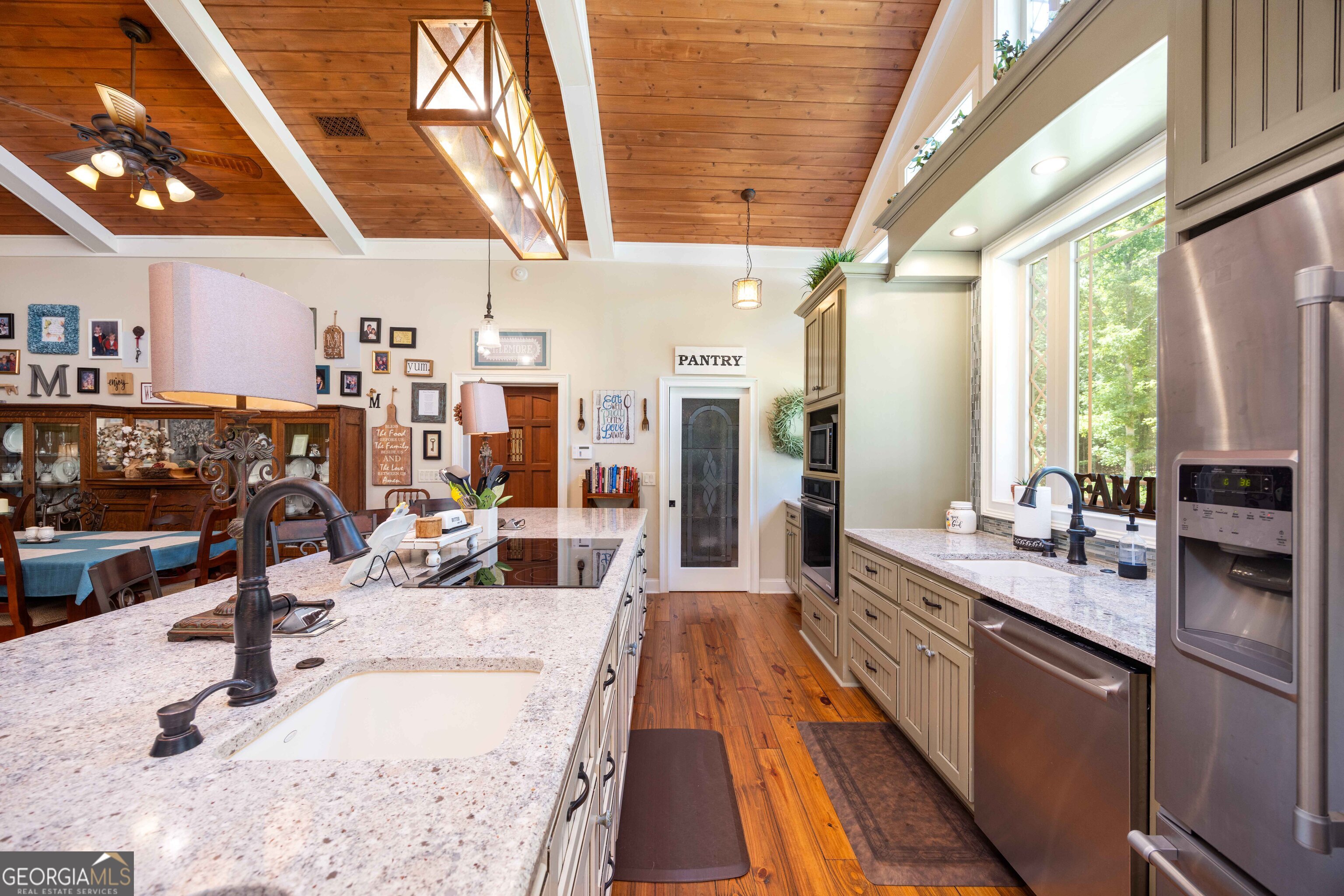 695 Boat Club Road Hamilton, GA 31811 - Photo 22 of 62 a large white kitchen with stainless steel appliances granite countertop a sink and counter space