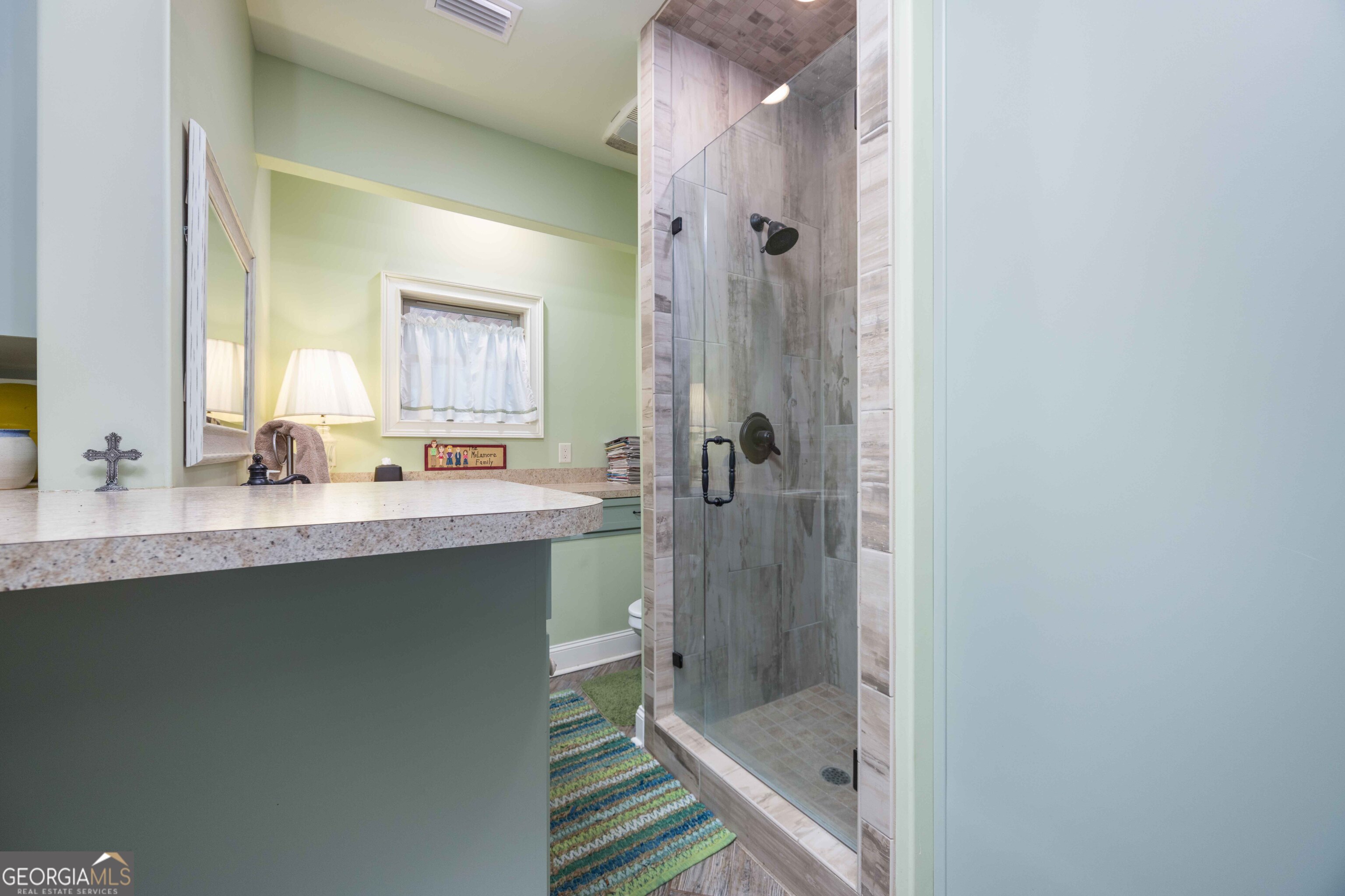 695 Boat Club Road Hamilton, GA 31811 - Photo 39 of 62 a bathroom with a shower sink and mirror