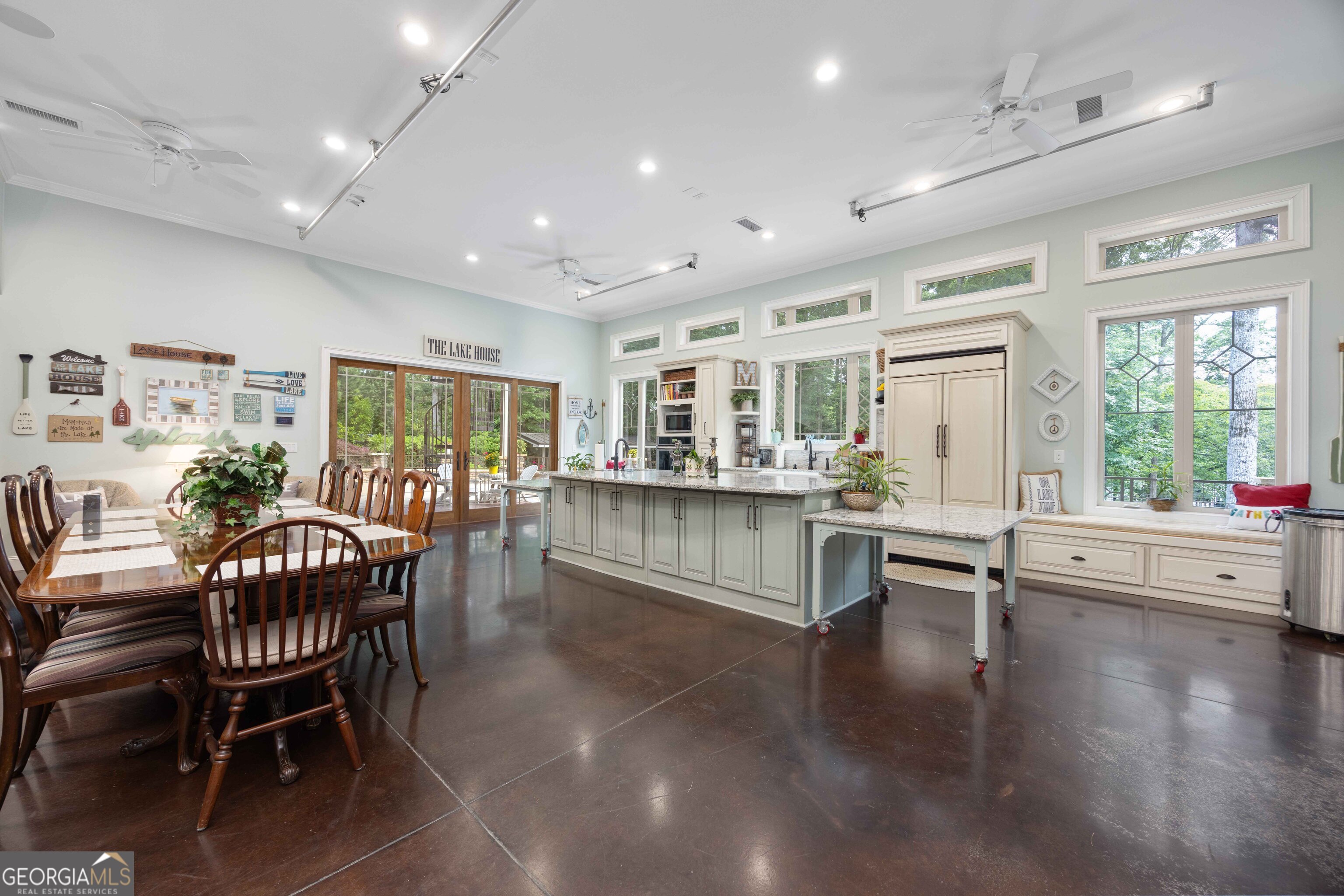 695 Boat Club Road Hamilton, GA 31811 - Photo 46 of 62 a dining hall with stainless steel appliances granite countertop a couch and a dining table with wooden floor