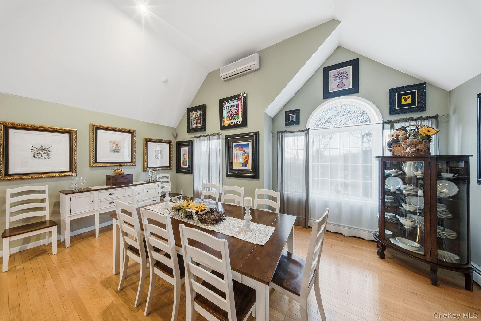 179 Reservoir Road Middletown, NY 10940 - Photo 15 of 50 Dining area featuring light wood-style floors, an AC wall unit, high vaulted ceiling, and a baseboard radiator