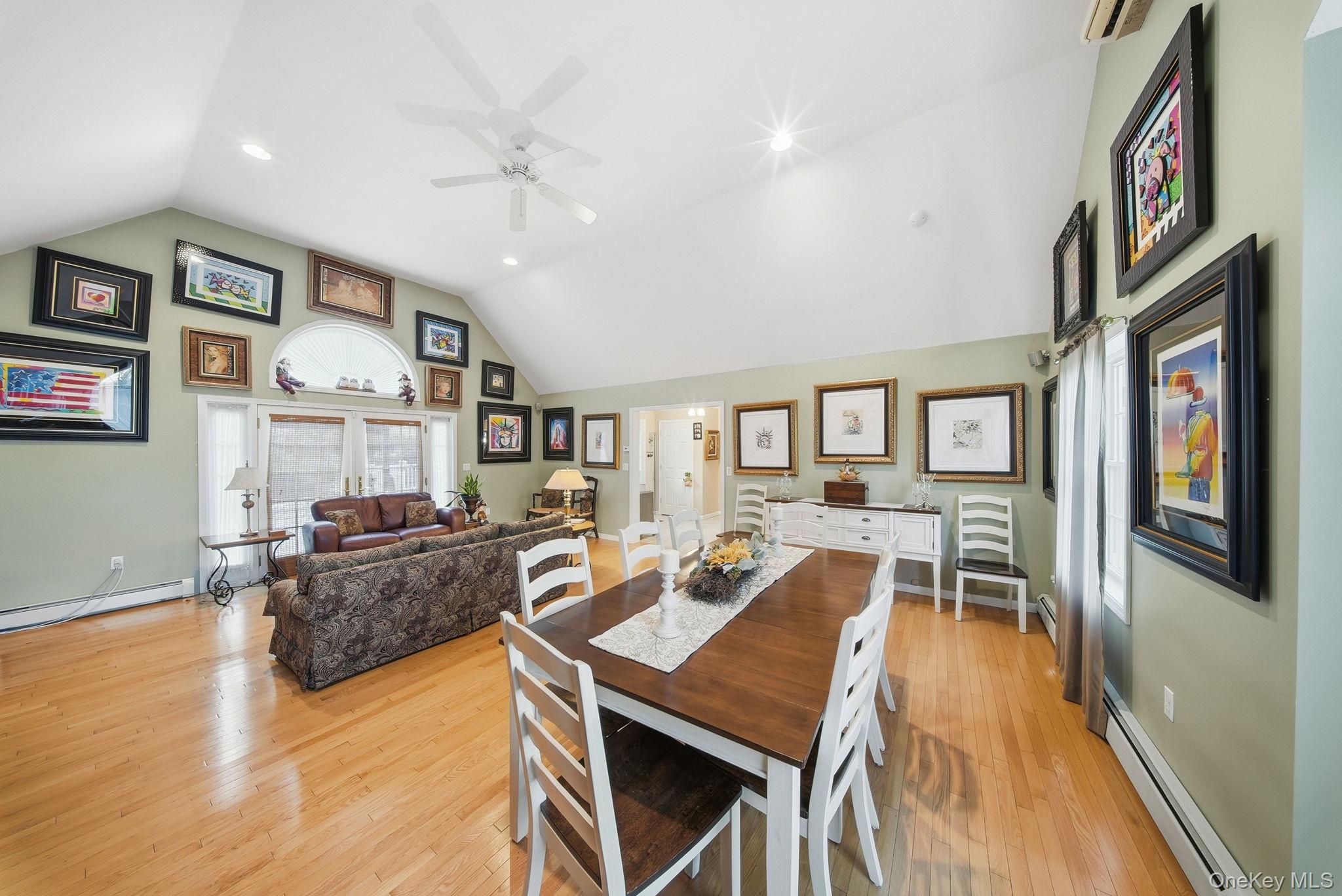 179 Reservoir Road Middletown, NY 10940 - Photo 16 of 50 Dining area with a baseboard heating unit, light wood finished floors, high vaulted ceiling, ceiling fan, and a wall mounted AC