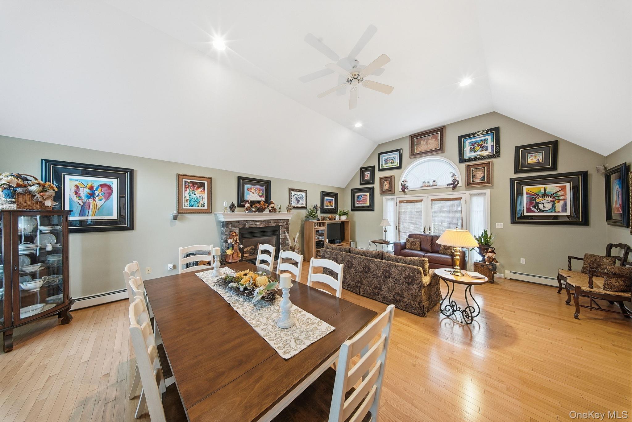 179 Reservoir Road Middletown, NY 10940 - Photo 17 of 50 Dining area with a fireplace, light wood-type flooring, a baseboard heating unit, high vaulted ceiling, and ceiling fan