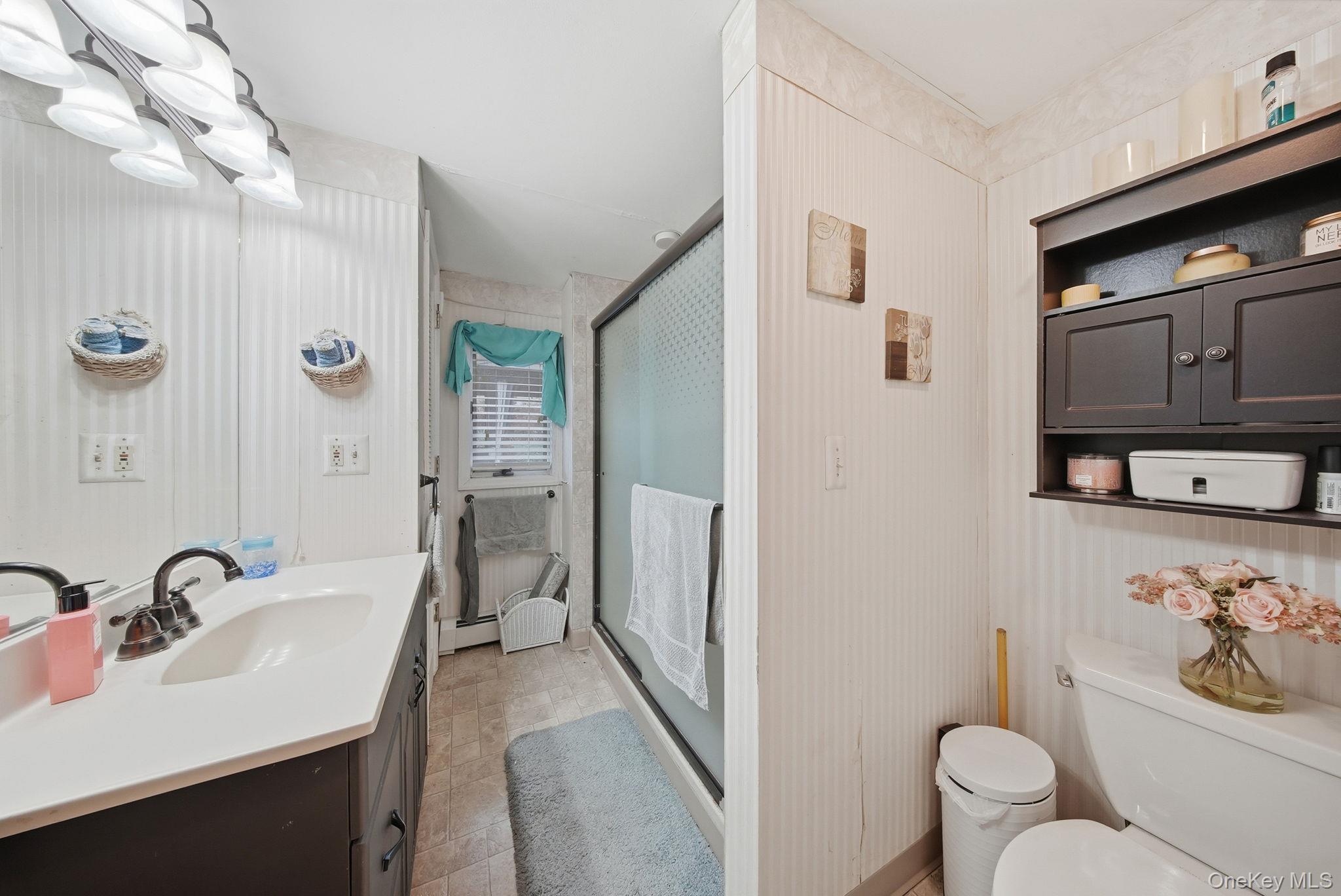 179 Reservoir Road Middletown, NY 10940 - Photo 20 of 50 Full bath featuring vanity, a shower stall, and baseboard heating