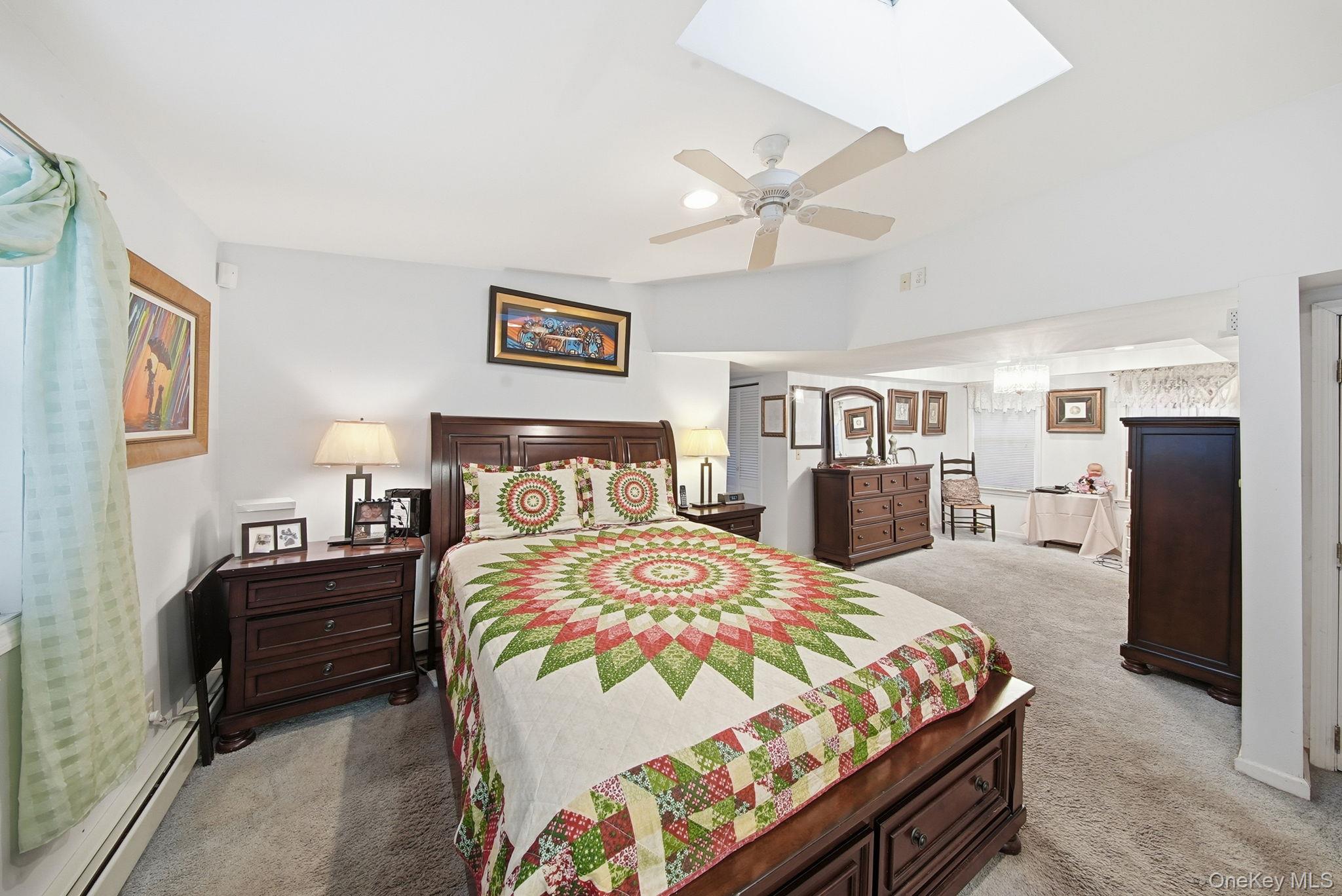 179 Reservoir Road Middletown, NY 10940 - Photo 29 of 50 Bedroom with light colored carpet, a skylight, ceiling fan, and baseboard heating