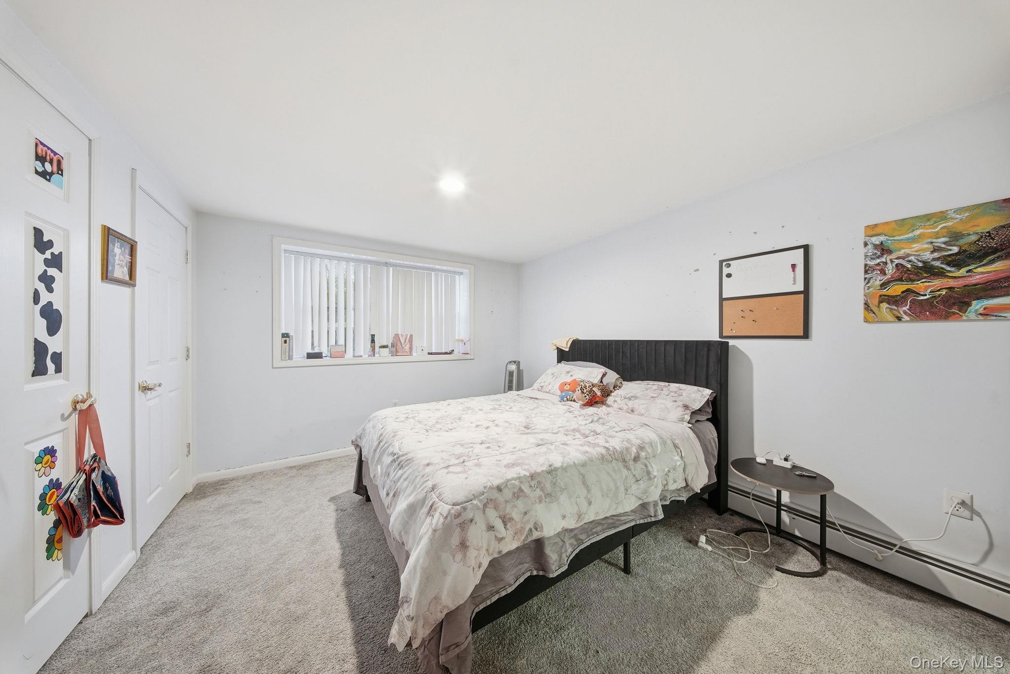 179 Reservoir Road Middletown, NY 10940 - Photo 37 of 50 Bedroom with light carpet and a baseboard heating unit