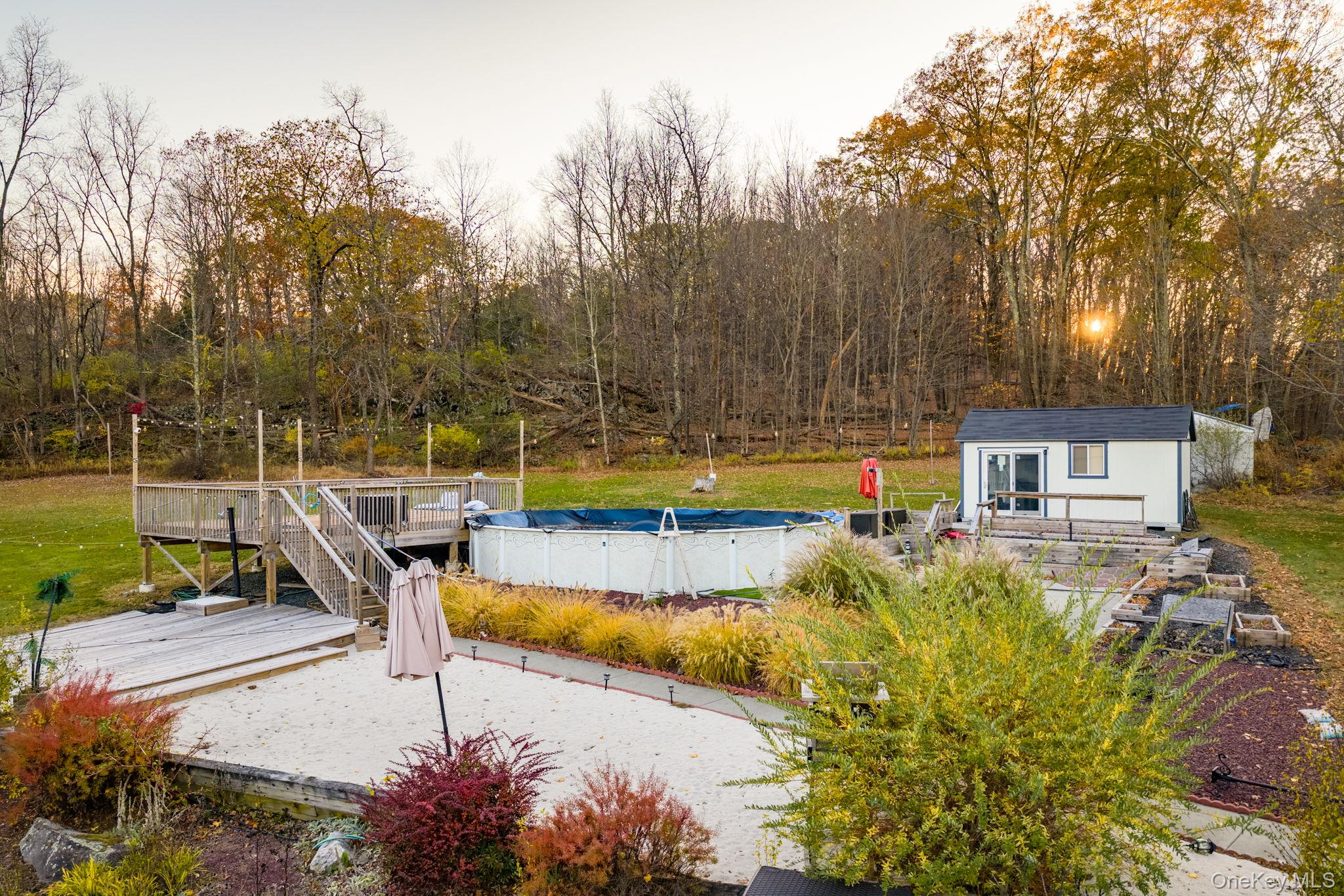 179 Reservoir Road Middletown, NY 10940 - Photo 44 of 50 View of pool featuring an outdoor structure, a covered pool, and a wooden deck