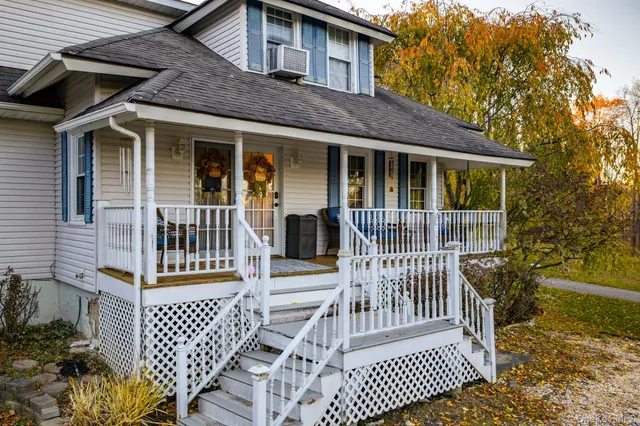a view of a house with a yard and sitting area