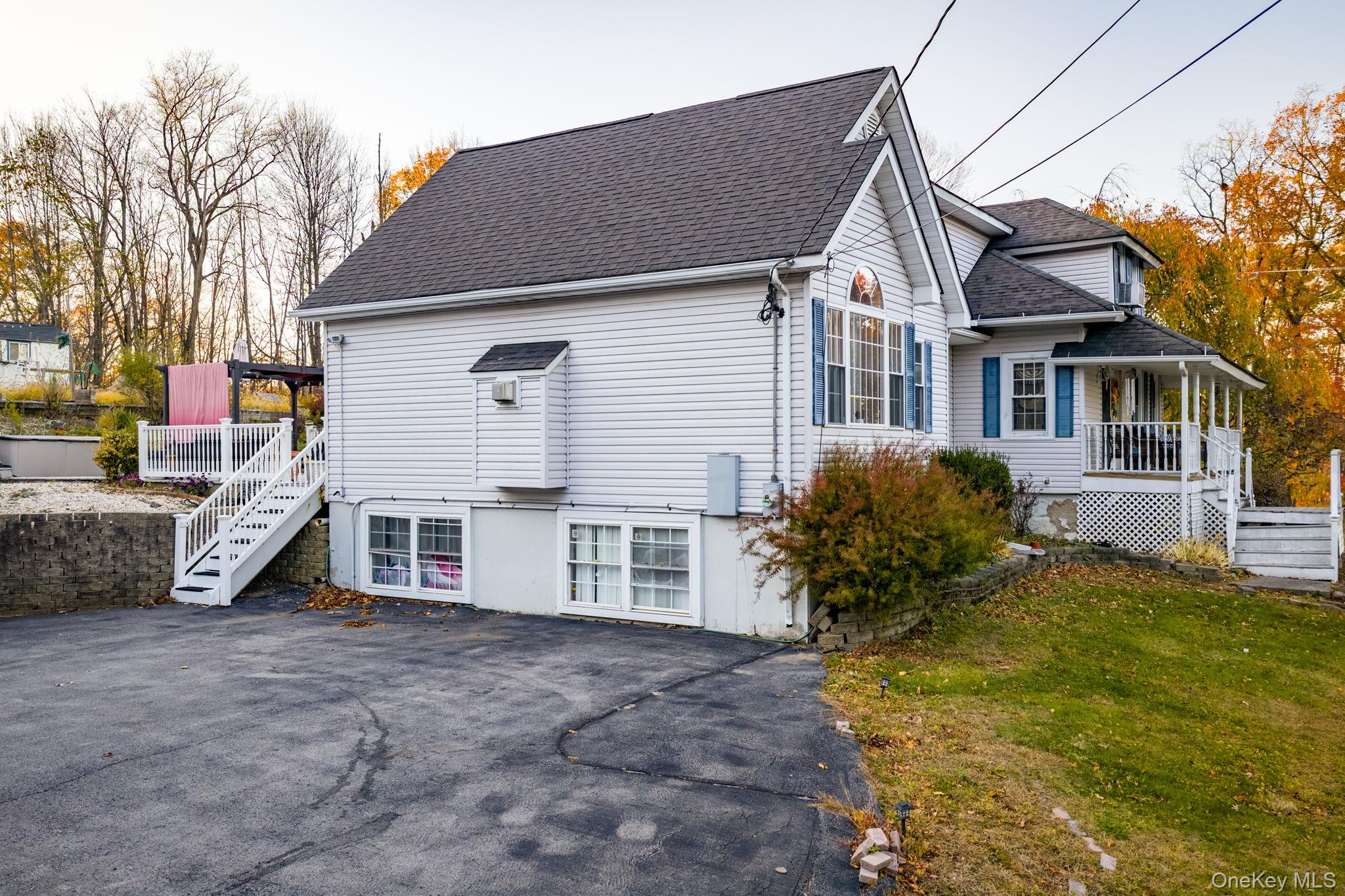 179 Reservoir Road Middletown, NY 10940 - Photo 7 of 50 View of home's exterior with stairs, a shingled roof, and a yard