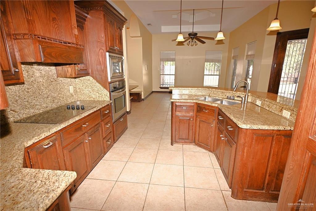 7931 Dallas Circle Mission, TX 78574 - Photo 14 of 33 a spacious bathroom with a granite countertop double vanity sink a mirror and a shower