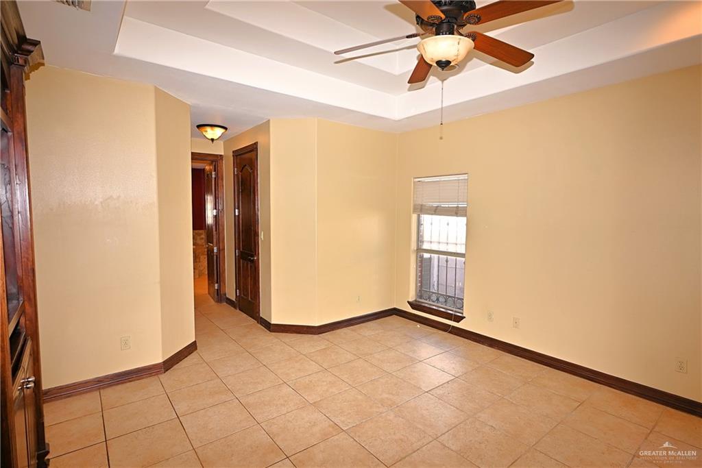 7931 Dallas Circle Mission, TX 78574 - Photo 19 of 33 a view of an empty room with chandelier fan and a window