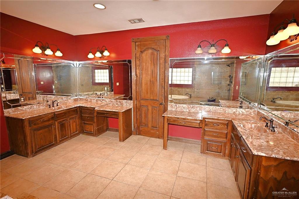7931 Dallas Circle Mission, TX 78574 - Photo 24 of 33 a large kitchen with stainless steel appliances a stove a sink dishwasher and cabinets