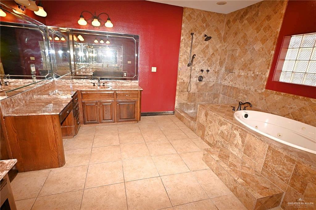 7931 Dallas Circle Mission, TX 78574 - Photo 25 of 33 a large bathroom with a tub a sink and a mirror