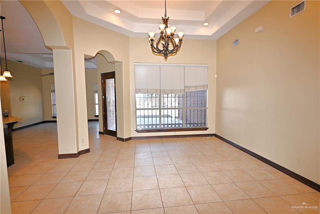 7931 Dallas Circle Mission, TX 78574 - Photo 8 of 33 a view of a room with a chandelier and large windows