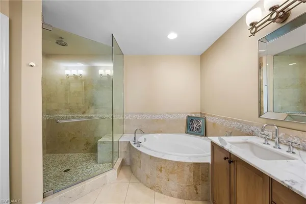 a bathroom with a granite countertop sink a toilet and shower