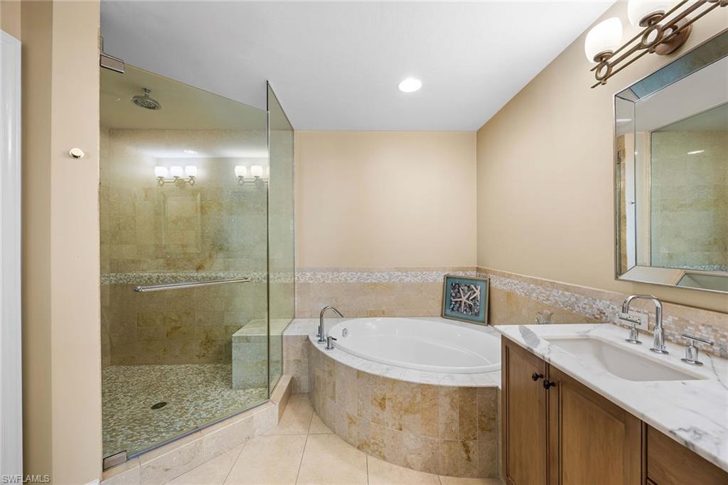 9123 Strada Place, Unit 7501 Naples, FL 34108 - Photo 14 of 28 a bathroom with a granite countertop sink a toilet and shower