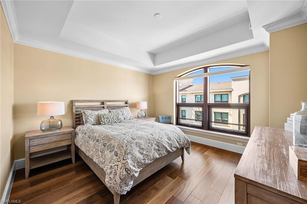 9123 Strada Place, Unit 7501 Naples, FL 34108 - Photo 15 of 28 a bedroom with a bed and a large window