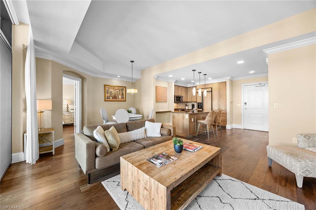 9123 Strada Place, Unit 7501 Naples, FL 34108 - Photo 6 of 28 a living room with furniture and wooden floor