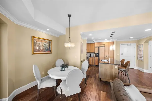 a view of a a dining room with furniture window and wooden floor
