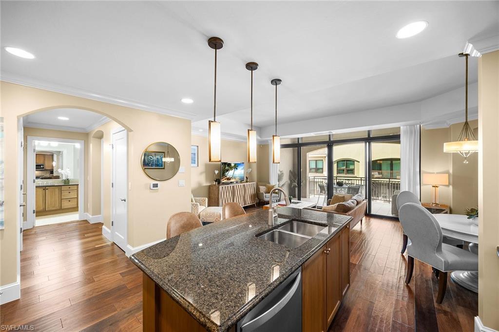 9123 Strada Place, Unit 7501 Naples, FL 34108 - Photo 10 of 28 a living room with furniture a large window and wooden floor