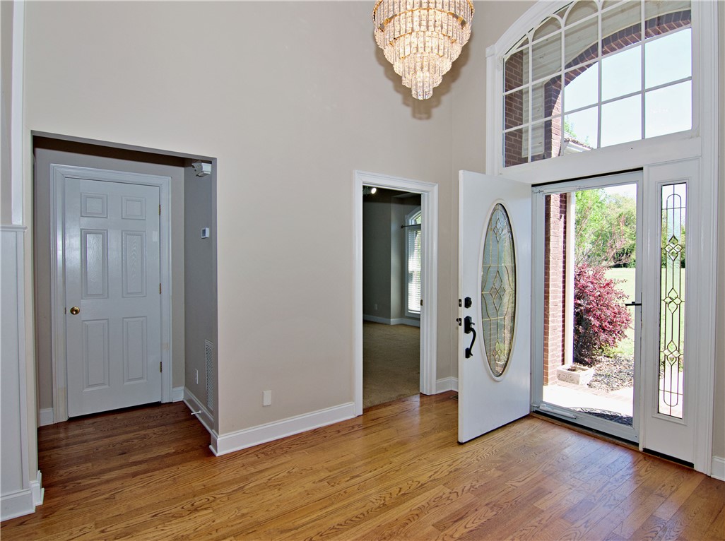 7893 Athens Road Carnesville, GA 30521 - Photo 5 of 50 Enter into a bright foyer featuring beautiful hardwood floors and a striking chandelier.