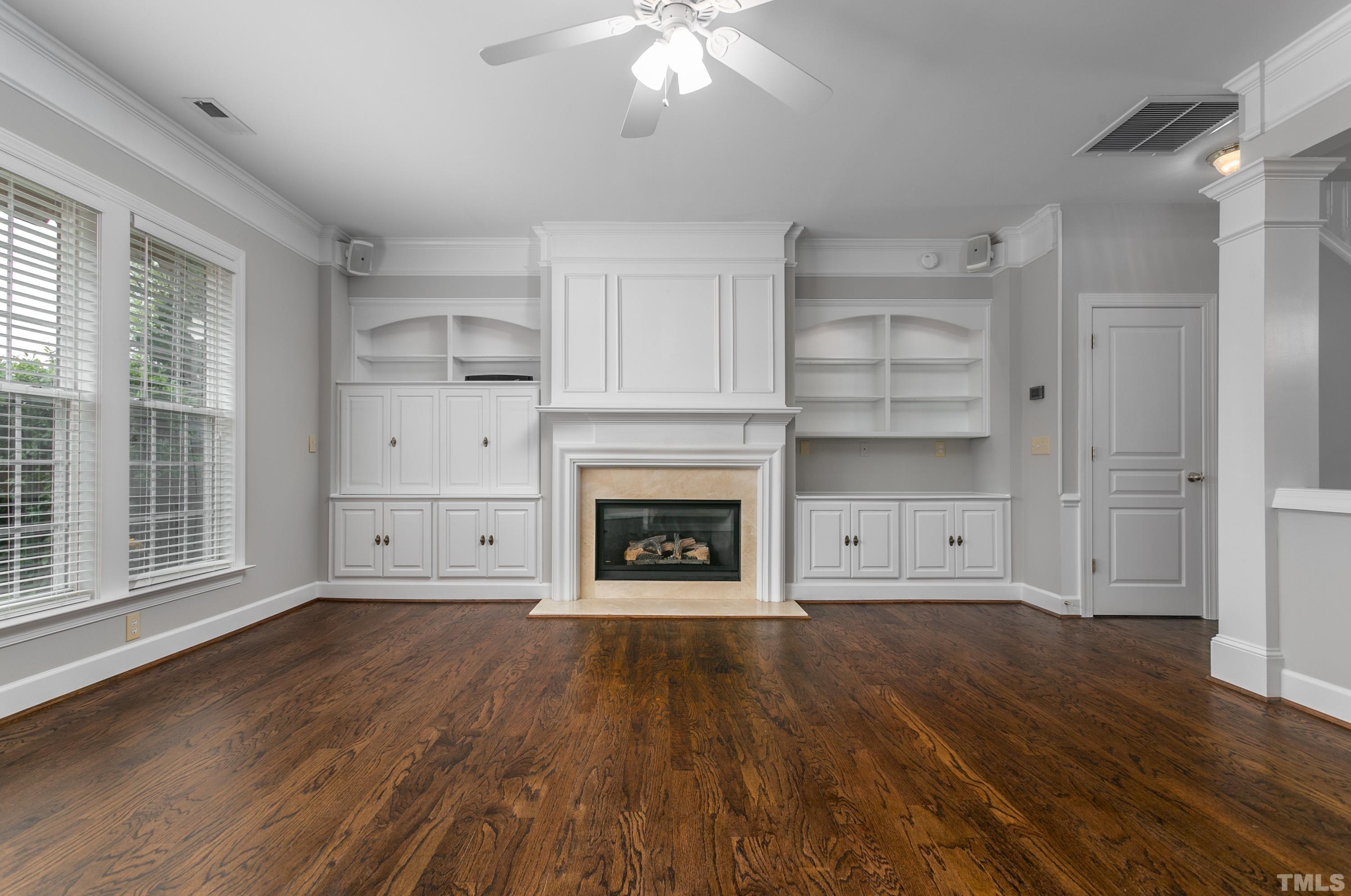 3620 Lion Ridge Court Raleigh, NC 27612 - Photo 15 of 23 a view of an empty room with wooden floor fireplace and a window