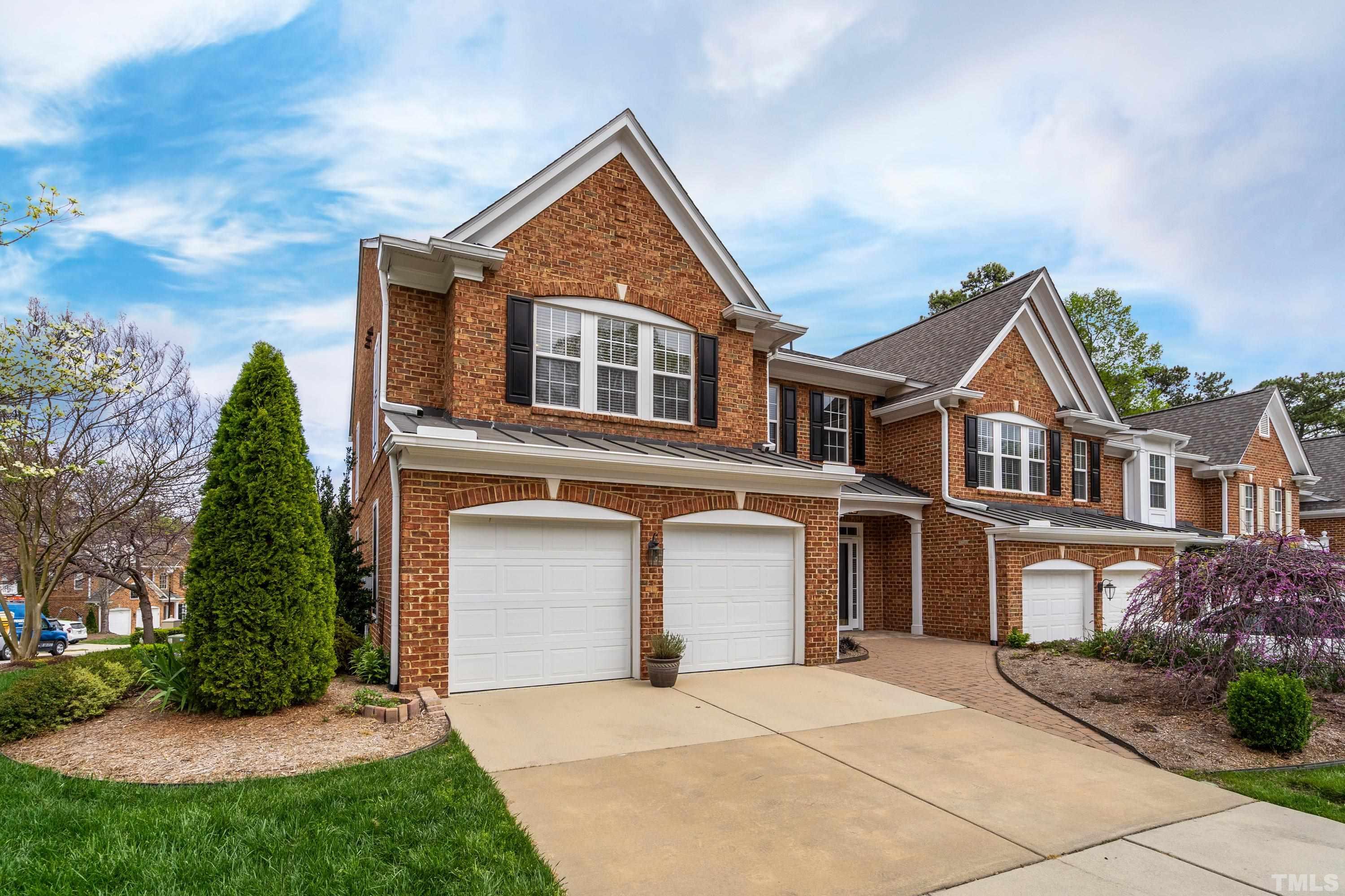 3620 Lion Ridge Court Raleigh, NC 27612 - Photo 16 of 23 a front view of a house with a yard and garage