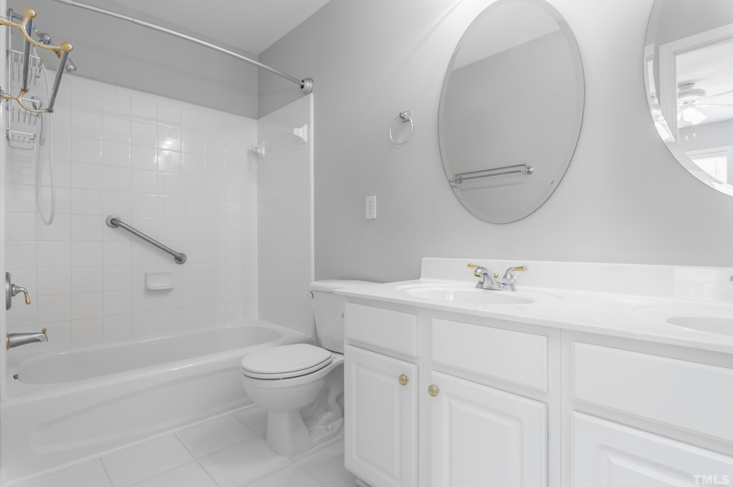 3620 Lion Ridge Court Raleigh, NC 27612 - Photo 17 of 23 a bathroom with a sink a toilet and a mirror