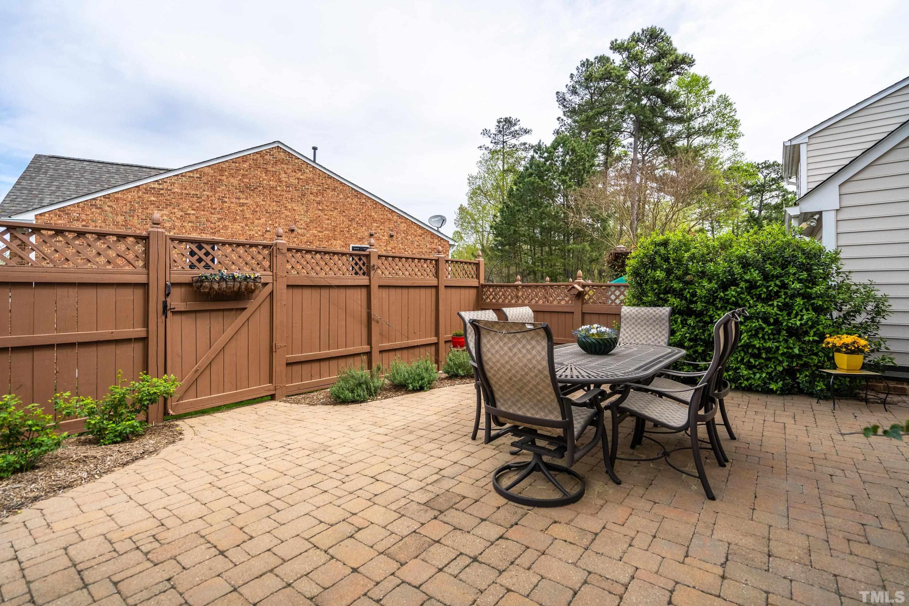 3620 Lion Ridge Court Raleigh, NC 27612 - Photo 10 of 23 a backyard of a house with table and chairs