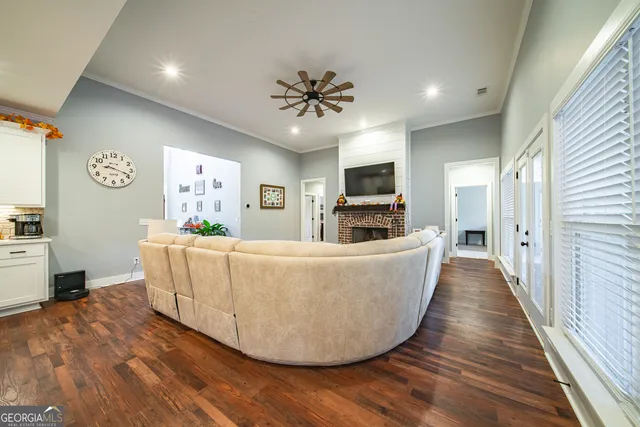 a large kitchen with stainless steel appliances kitchen island granite countertop a large counter top and wooden floors