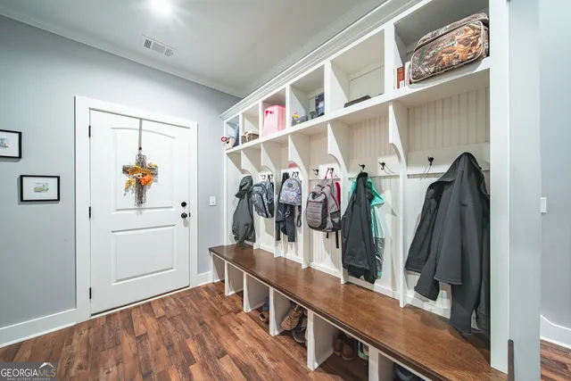 a spacious bedroom with a bed and a chandelier