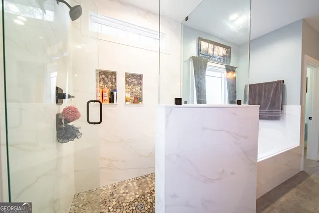 a bedroom with furniture and a flat screen tv