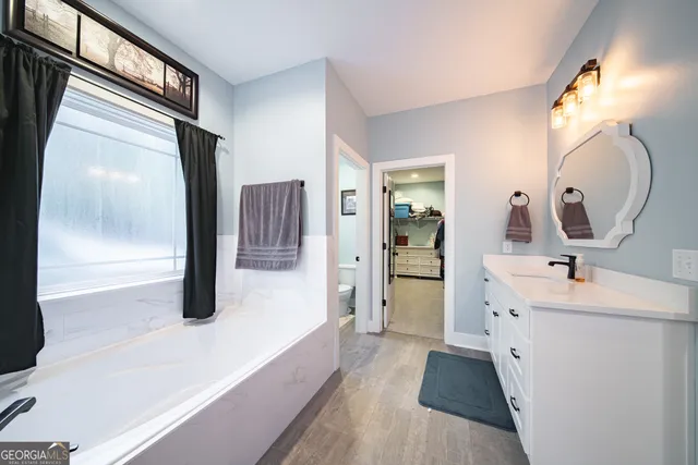 a bathroom with a toilet sink and mirror