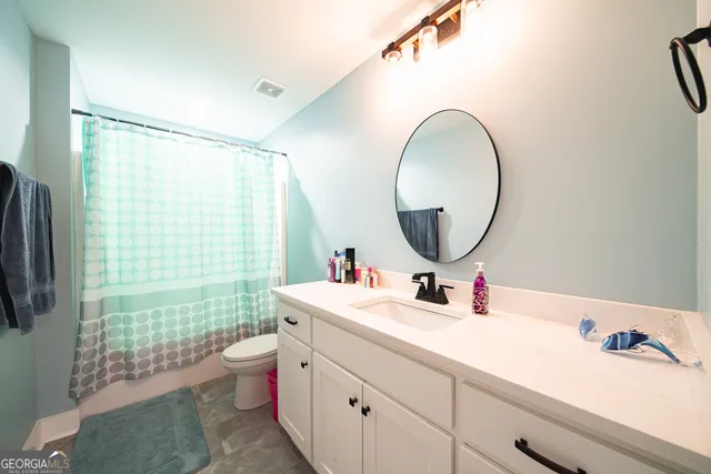 a bathroom with a sink mirror and vanity