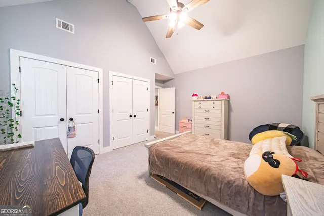 a bathroom with a toilet and a shower curtain