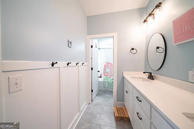 a bathroom with a toilet sink vanity tub and shower
